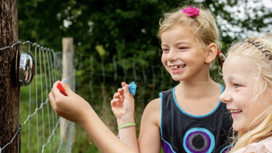 Children playing outdoors with a bell dart