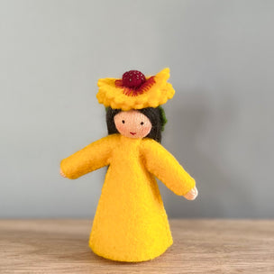 A felt Firewheel Flower Fairy wearing golden yellow dress and firewheel flower on her head with light/medium skin tone | © Conscious Craft
