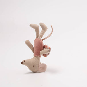 Stuffed animal toy with pink body and beige antlers on a white background