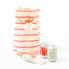 Maileg red and white stripe cotton pull string bag with beach essentials including suncream and two cans of drink | © Conscious Craft