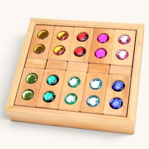 Wooden puzzle with colored gemstones on a white background