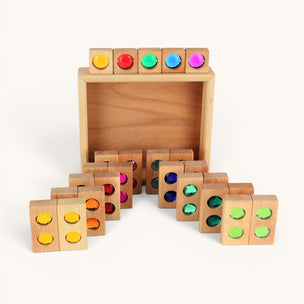 Set of wooden blocks with colored dots on a white background
