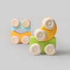 Colorful wooden toy cars with wheels on a gray background