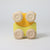 Grimm's Yellow toy car with wooden wheels on a light gray background