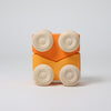 Wooden toy cars with orange body and beige wheels on a light gray background