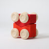 Red wooden toy cars with beige wheels on a white background
