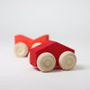 Grimm's Red wooden toy car with beige wheels on a light gray background
