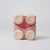 Grimm's Pink toy car with beige circular pieces on a light gray background