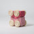 Pink wooden toy car with wheels on a light gray background