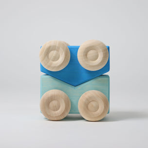 Grimm's Wooden toy car blocks with blue and beige colors on a light gray background
