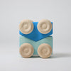 Grimm's Wooden toy car blocks with blue and beige colors on a light gray background