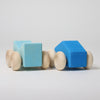 Grimm's Two blue wooden  car blocks with wooden wheels on a light gray background