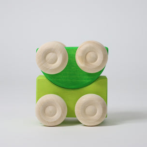 Grimm's Two green wooden toy cars on a light gray background