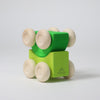 Grimm's Green wooden toy car with wheels on a light gray background