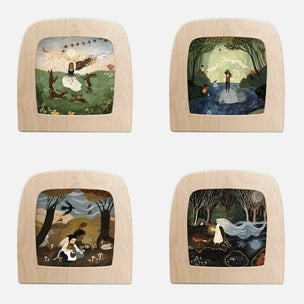 Four square wooden wall art pieces arranged in a 2x2 grid on a light gray background. Each piece has a natural wood frame with a painted fantasy scene in the center, including figures, trees, water, and celestial elements.