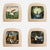 Four square wooden wall art pieces arranged in a 2x2 grid on a light gray background. Each piece has a natural wood frame with a painted fantasy scene in the center, including figures, trees, water, and celestial elements.