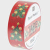Roll of decorative tape with Christmas tree design on a red background