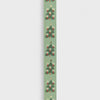 Decorative ribbon with Christmas tree pattern on a light green background