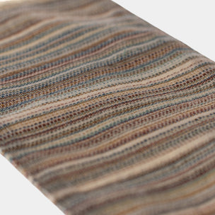 Close-up of a Maileg rug with horizontal stripes on a white background