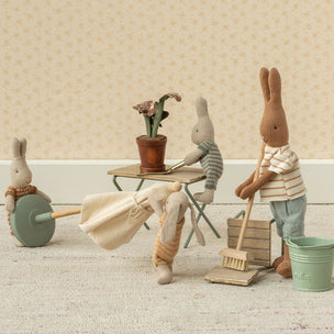 Miniature Maileg scene with toy bunnies engaged in cleaning activities on a neutral background