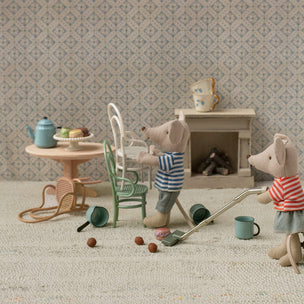 Miniature mouse figures in a kitchen setting with furniture and kitchenware.