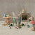 Miniature mouse figures in a kitchen setting with furniture and kitchenware.