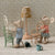 Two toy mice in a miniature room with furniture and decor.