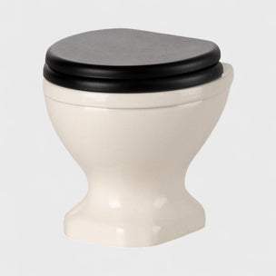 Maileg Mice toilet with a black seat on a light gray background.