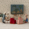 Miniature scene of mice watching a picnic-themed picture on a screen.