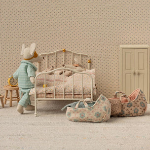 Maileg Miniature bedroom scene with a child's bed, toys, and furniture in a dollhouse setting.