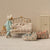 Maileg Miniature bedroom scene with a child's bed, toys, and furniture in a dollhouse setting.
