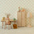 Children's room with floral wallpaper, desk, chair, cabinet, and lamp.