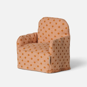 A miniature Maileg armchair upholstered in a textured peach fabric with a brown polka-dot pattern, shown on a light gray background.
