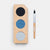 Three-color eye shadow palette with a brush on a white background