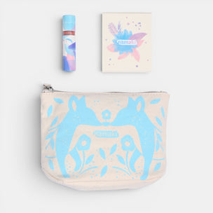 Pouch with blue fox design, lip balm, and notebook on a white background