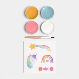 Set of colorful paint pots with a paintbrush and painted designs on a white background