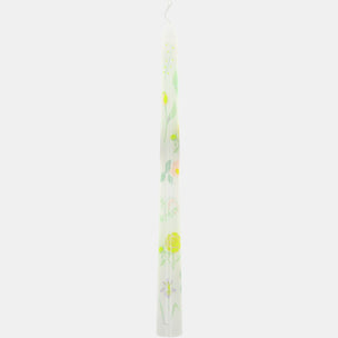 Tall candle with floral design on a white background