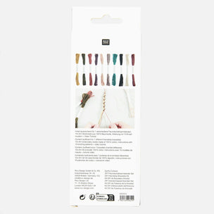 The back of a white embroidery floss package, showing a grid of color swatches, a sample of white embroidery thread wrapped around a needle, and product details in German and English.