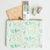 Floral-patterned pouch with stationery items on a white background