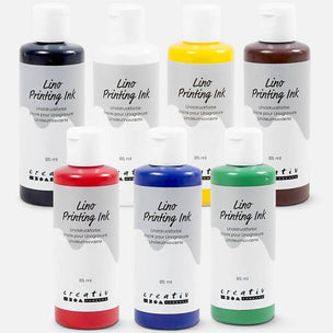 Seven bottles of Creativ Lino Printing Ink in various colors (black, white, yellow, brown, red, blue, green) arranged on a clean white background.