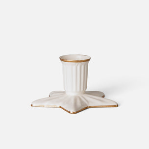 An off-white Maileg candle holder with a ribbed cylindrical cup and a star-shaped base, accented with a metallic gold rim, set against a plain light gray background.