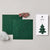 Felt Christmas tree kit components laid out on a light gray background, including two dark green felt tree shapes with stitched outlines, a ball of white fluffy stuffing, a small bundle of red, green, and white striped thread, and an instruction booklet with a tree illustration.