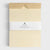 Packaged product with a beige cover and white label on a light gray background