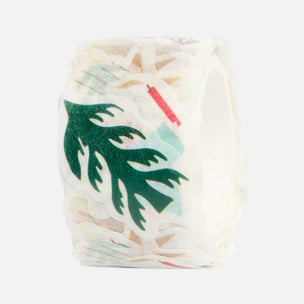 A roll of washi tape featuring a tropical green palm leaf pattern on a white base, with subtle pastel multicolor accents visible through the translucent tape.