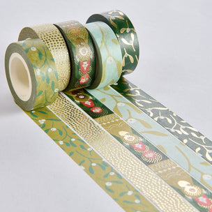A set of decorative washi tapes with various patterns including floral, geometric, and botanical designs in muted green, beige, light blue, and gold tones, arranged on a light gray background.