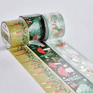 Three rolls of decorative washi tape with festive woodland and winter illustrations, including carrots, mushrooms, stars, and snowflakes, displayed on a light gray background.