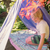 Child playing under a colorful tent in a garden