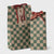 Maileg Two checkered gift bags with red ribbons and Santa Claus tag on a white background