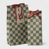 Maileg Two checkered gift bags with red ribbons and Santa Claus tag on a white background