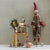 Maileg Decorative scene with a gnome, chair, and small figurines against a neutral wall.